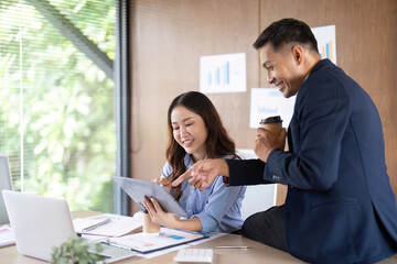 Teamwork and Collaboration. Colleagues reviewing project data on a tablet.