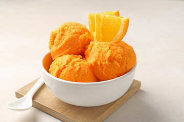 Tasty orange sorbet, fresh fruit and spoon on light table, closeup