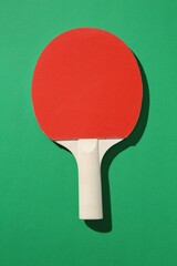 One ping pong racket on green background, top view