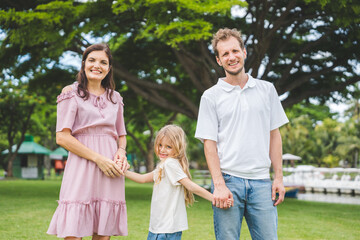 Fototapeta premium Happy family parent children having picnic outdoor activity. Enjoy happiness moment summer playing together including father mother son and daughter relaxing in the morning sunrise.