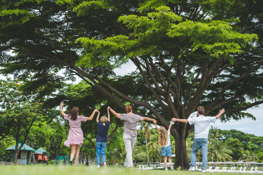 Happy family parent children having picnic outdoor activity. Enjoy happiness moment summer playing together including father mother son and daughter relaxing in the morning sunrise.