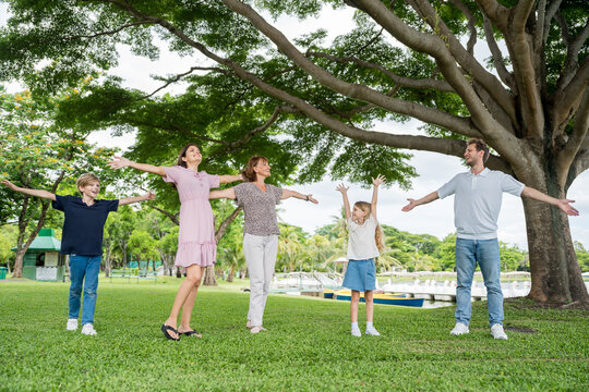 Happy family parent children having picnic outdoor activity. Enjoy happiness moment summer playing together including father mother son and daughter relaxing in the morning sunrise.