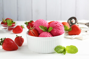 Tasty sorbet with strawberries and mint served on white wooden table, closeup