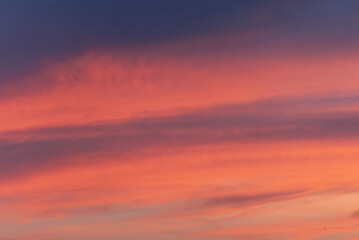 Vibrant sunset sky with soft, colorful clouds displaying a beautiful gradient of orange, pink, and purple hues. Natural Beauty