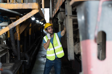 Locomotive repair garage, Mechanic, Engine Mechanic. Engineer checking, repairing, maintaining locomotive engine. Railway engineer and train wheel in train garage