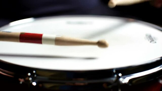 Drumming on Snare Drum with Drumsticks Close Up