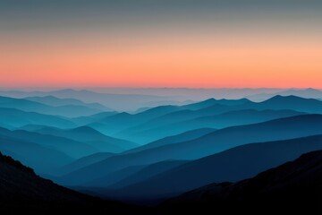 Fototapeta premium Multiple layers of blue mountains create a serene landscape under a colorful sunset sky.