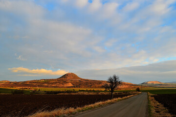 Curved Country Road in Rolling Hills with Clouds and Early Light