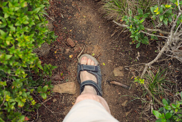 downward view of the foot of a hiker with hiking sandal
