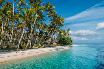 Paradise beach with palm trees and quiet sea on tropical island. Travel luxury vacation banner.