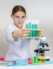 Laboratory research test tubes reagents and microscope. Selective focus.