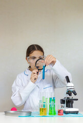 Laboratory research test tubes reagents and microscope. Selective focus.