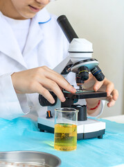 Laboratory research test tubes reagents and microscope. Selective focus.