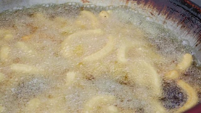 Deep-fried Chinese crullers in oil in a pan