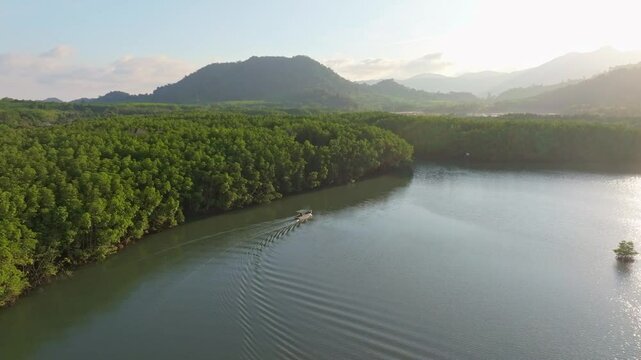 Drone shot of Salak Khok mangroves glowing under sunset skies, Koh Chang, Thailand. Aerial drone video