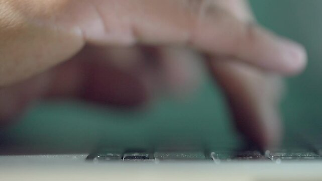 A person is typing on a keyboard. The person is using the space bar. The person is using the shift key