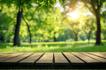 Naklejka premium A rustic wooden table in focus with a blurred background of a serene park filled with vibrant green trees and sunlight filtering through.