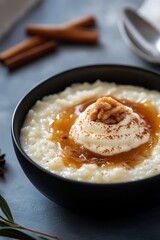 Creamy rice pudding topped with whipped cream and nuts in a bowl  