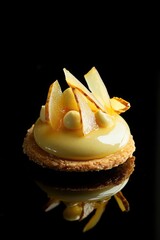 Almond tart shell filled with creamy yuzu mousse topped with fruit  