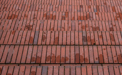 Naklejka premium The staircase is made of red brick after the rain.