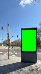 Urban billboard basking in vibrant green square on sunlit crossroads, evoking Dia de los Muertos...