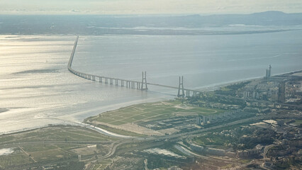 Expansive Lisbon  bridge slicing through silver waters, symbolizing unity and transcendence,...