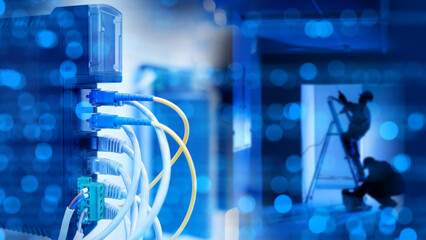 Technicians install and connect Ethernet and fiber optic cables in a data center. Close-up on...