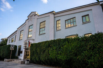 Front facade of the National Art Gallery for Foreign Art with Bulgarian flag and symmetrical windows in Sofia, Bulgaria at sunset