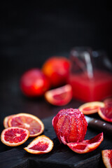 Fresh ripe red blood oranges (sicilian) on dark background