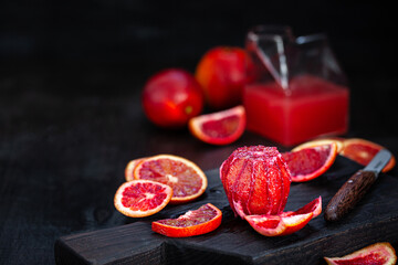Fresh ripe red blood oranges (sicilian) on dark background