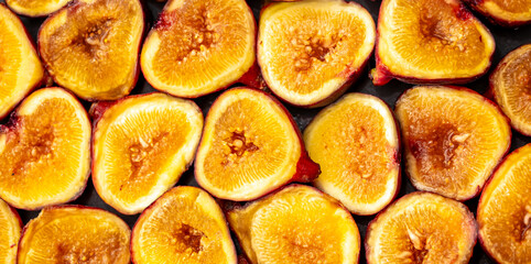 Figs close-up. Heap of figs, whole fruits and cut in half. Sweet exotic fruit for dessert, healthy food.