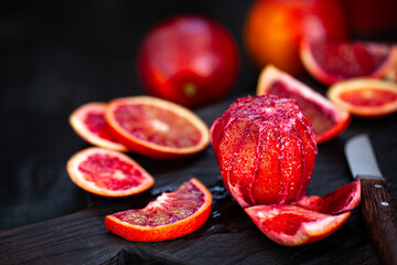 Fresh ripe red blood oranges (sicilian) on dark background