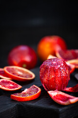 Fresh ripe red blood oranges (sicilian) on dark background