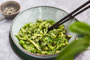 Asian style chuka wakame seaweed or sea mustard, cucumbers, green lettuce and sesame seeds fresh salad