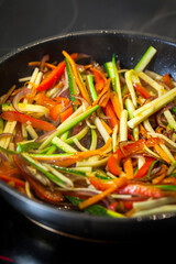 Asian glass noodle stir-fry with chicken and vegetables in a rustic ceramic  bowl