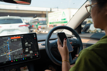 Business woman use smartphone while drive car
