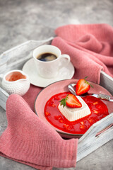 Delicious Italian dessert Panna Cotta with strawberry sauce and fresh berries