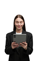 Naklejka premium Young woman engaging with a tablet while dressed in a stylish black blazer at a creative workspace