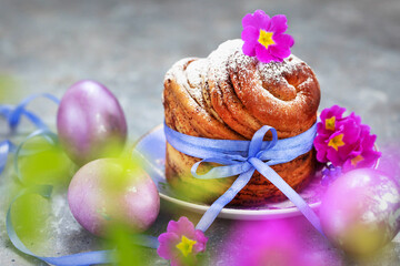 Sweet Easter bread, panettone or cruffin and colorful painted eggs, Holiday spring concept