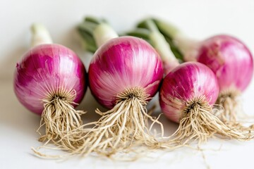 A close-up view of vibrant, fresh onion bulbs showing their papery outer layers and fresh roots.