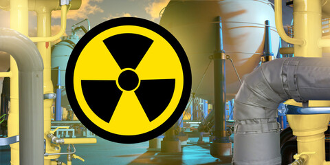 Radiation hazard symbol overlaid on industrial facility with pipelines and spherical tanks,...