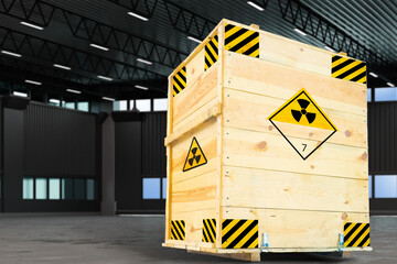 Wooden crate marked with radioactive warning symbols stored in an industrial warehouse, indicating...