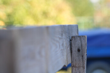 A close-up of a wooden plank, focusing on its texture and grain, with a blurred background adding...