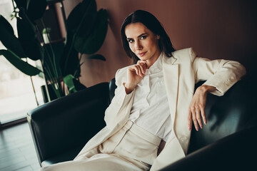 Successful female business professional in a modern office setting exuding confidence, style, and...