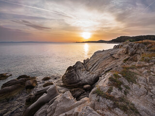 Breathtaking sunset over rocky coastline at peaceful seaside location Toroni on Sithonia peninsula, Greece