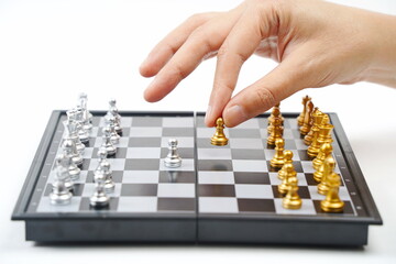 The chessboard. The hand holds the figure. Strategy, business, political games and diplomacy.