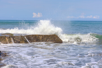 Fototapeta premium Tanah Lot Temple on the island of Bali known as the island of Gods. Sitting on top of rock island over looking turquoise blue beaches in Bali Indonesia