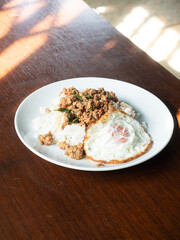 Pad Kaprao, Thai stir fried minced pork with holy basil leaves, served with rice and sunny side up