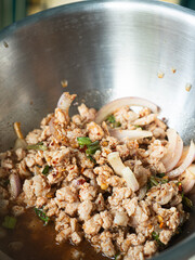 Larb Moo, Thai northeastern style spicy minced pork salad in mixing bowl