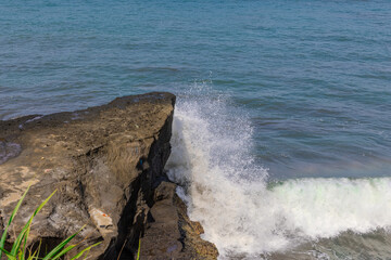 Tanah Lot Temple on the island of Bali known as the island of Gods. Sitting on top of rock island over looking turquoise blue beaches in Bali Indonesia